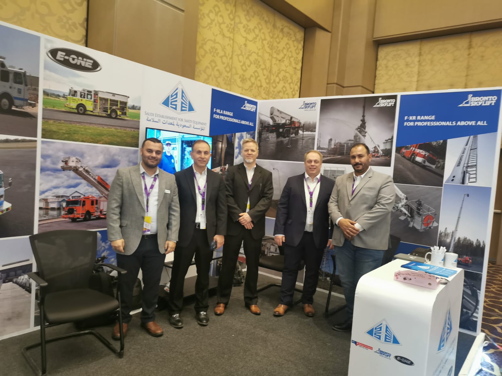 five men standing in the business expo