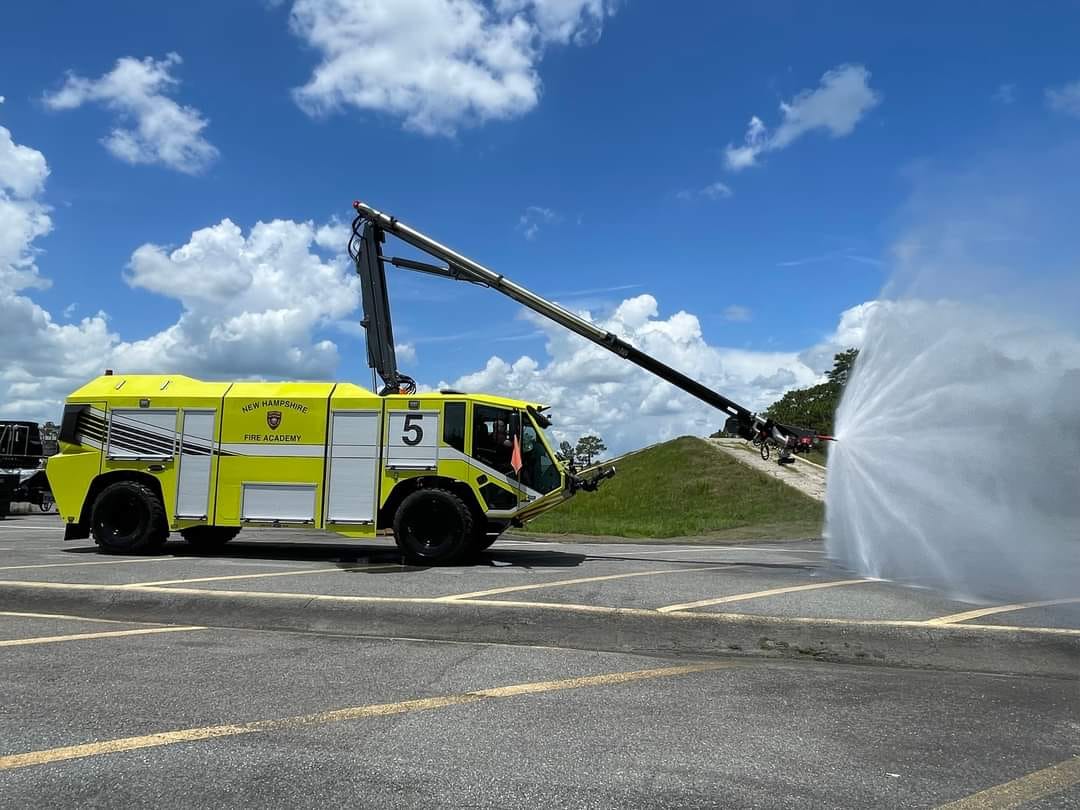 Yellow fire truck blowing water