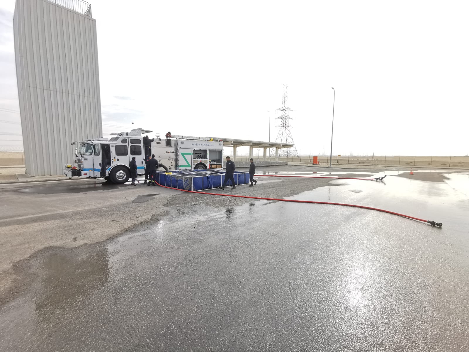 Men in the field checking the fire truck