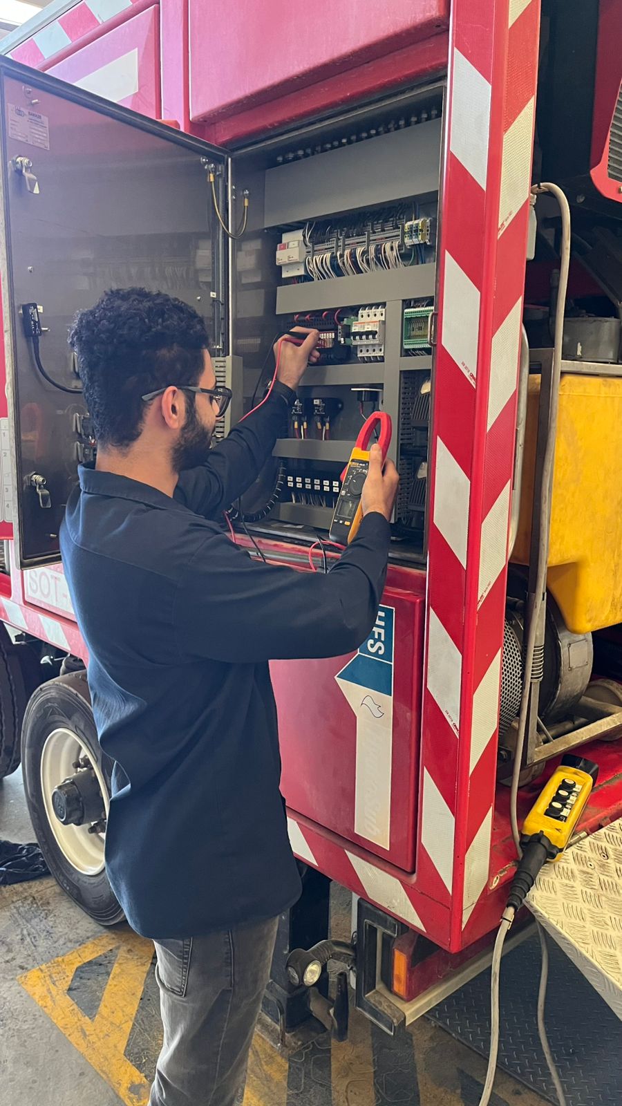 Man checking the wirings of the fire truck
